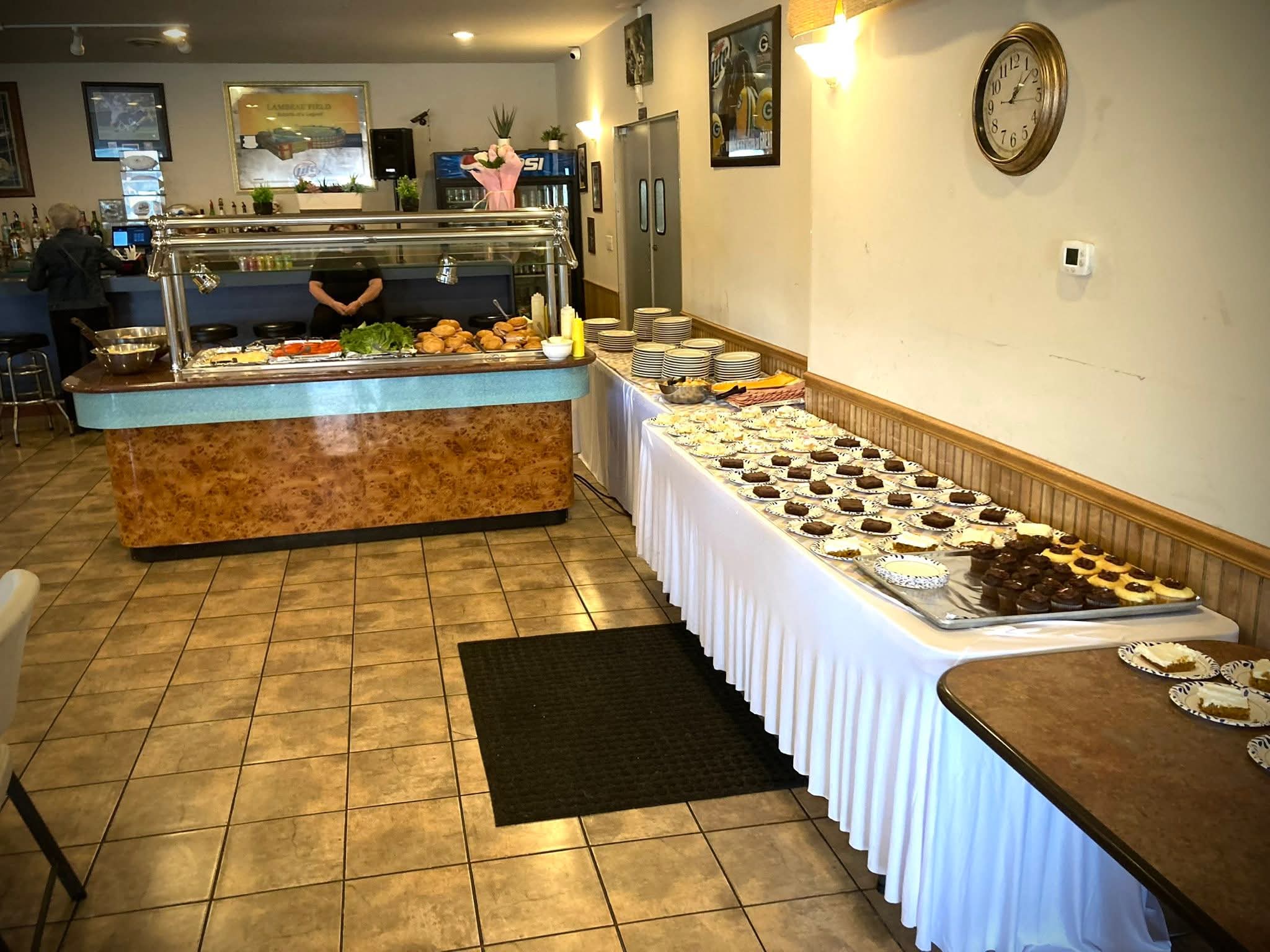 Buffet station and dessert tables set along the wall