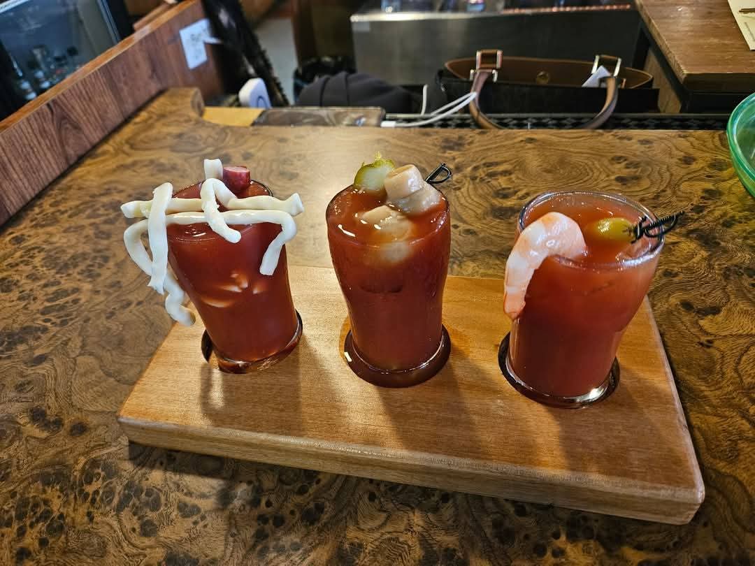 Bloody mary flight with cheese, sausage, and shrimp garnishes
